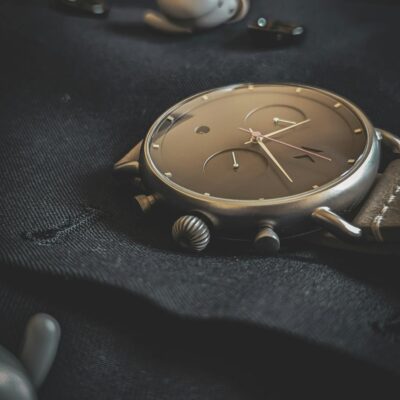 Stylish wristwatch lying on a dark fabric, emphasizing luxury and elegance.